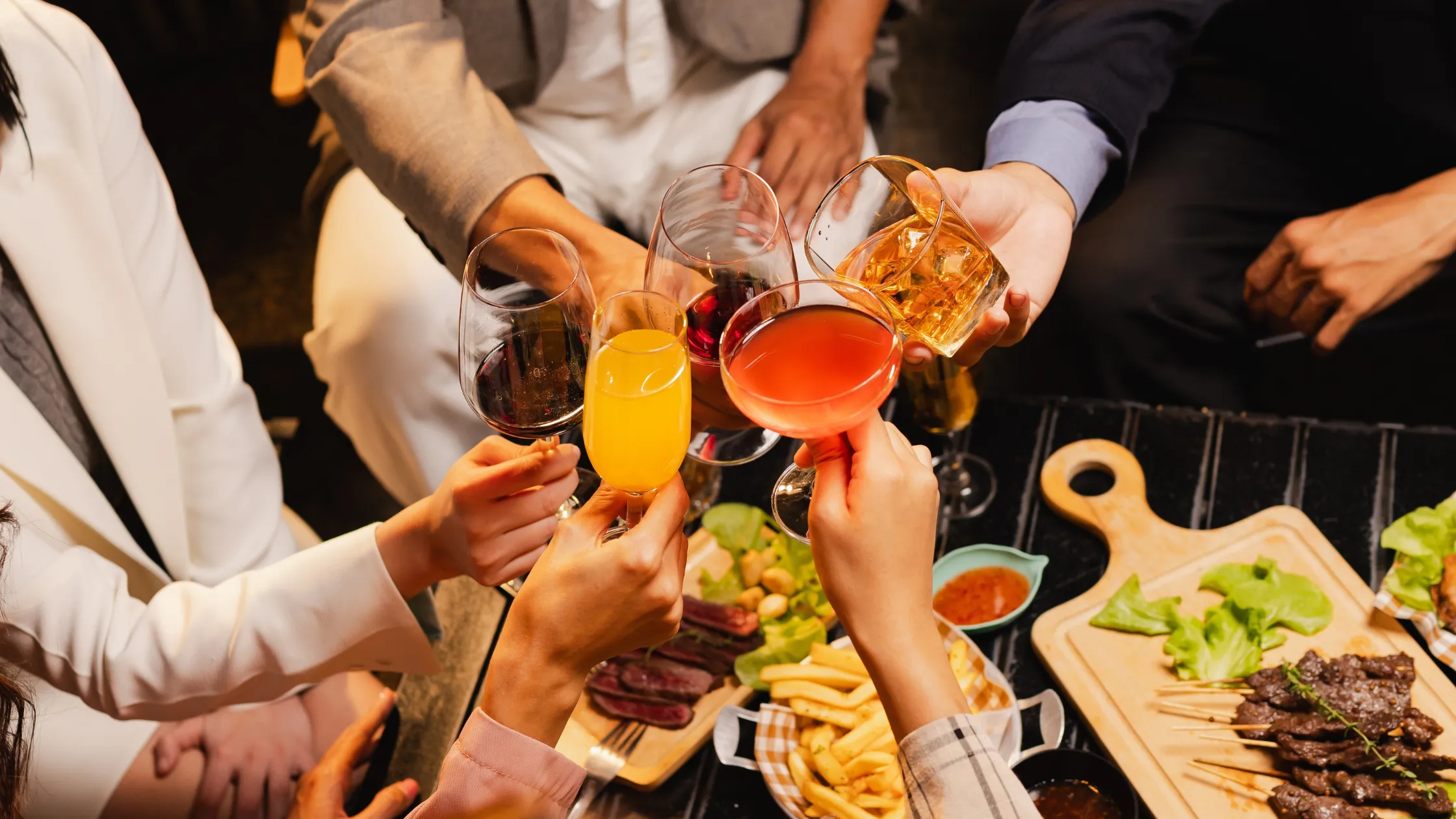 Budget-friendly Super Bowl party setup with cocktails, beer, and garnished glasses.